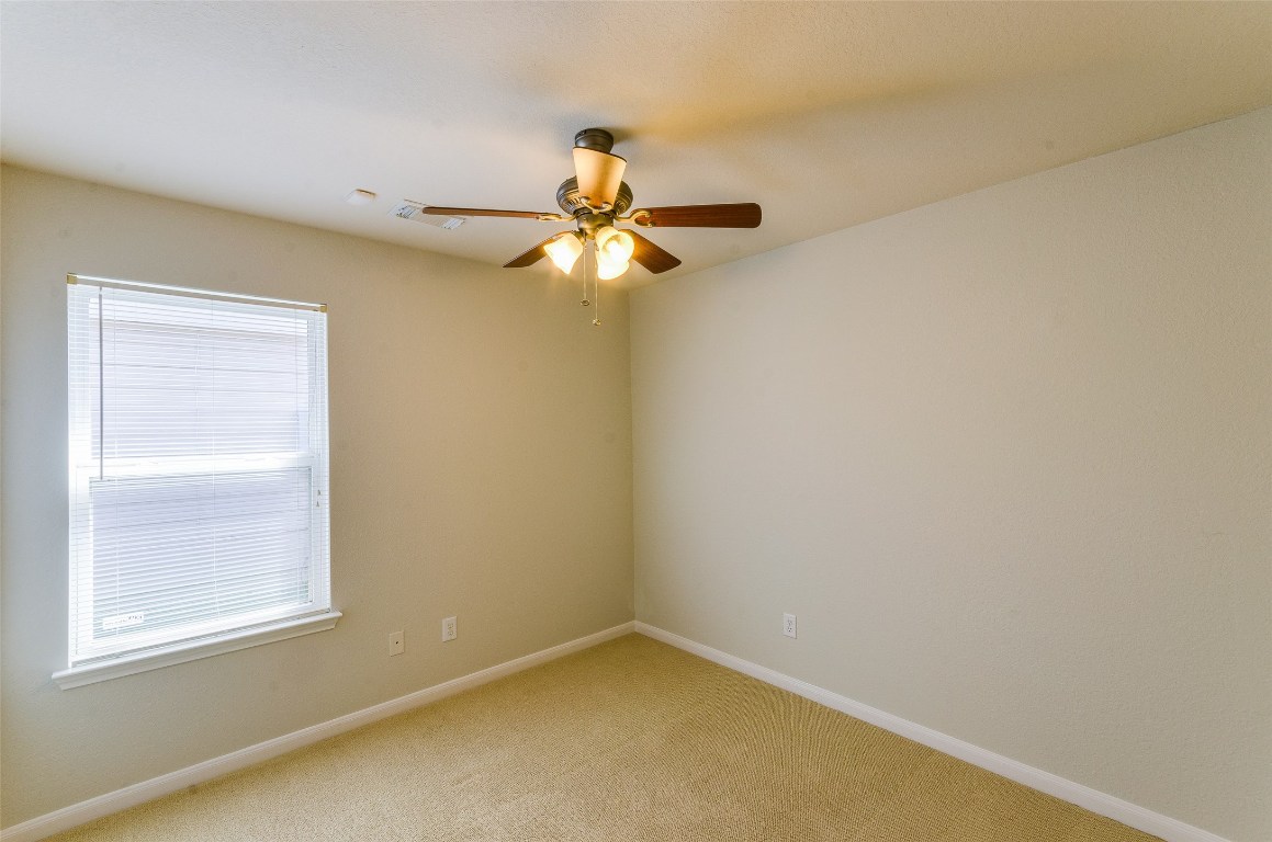 3302 Legends Landing Drive Spring, TX 77386 - Photo 31 of 48 an empty room with a window and a fan