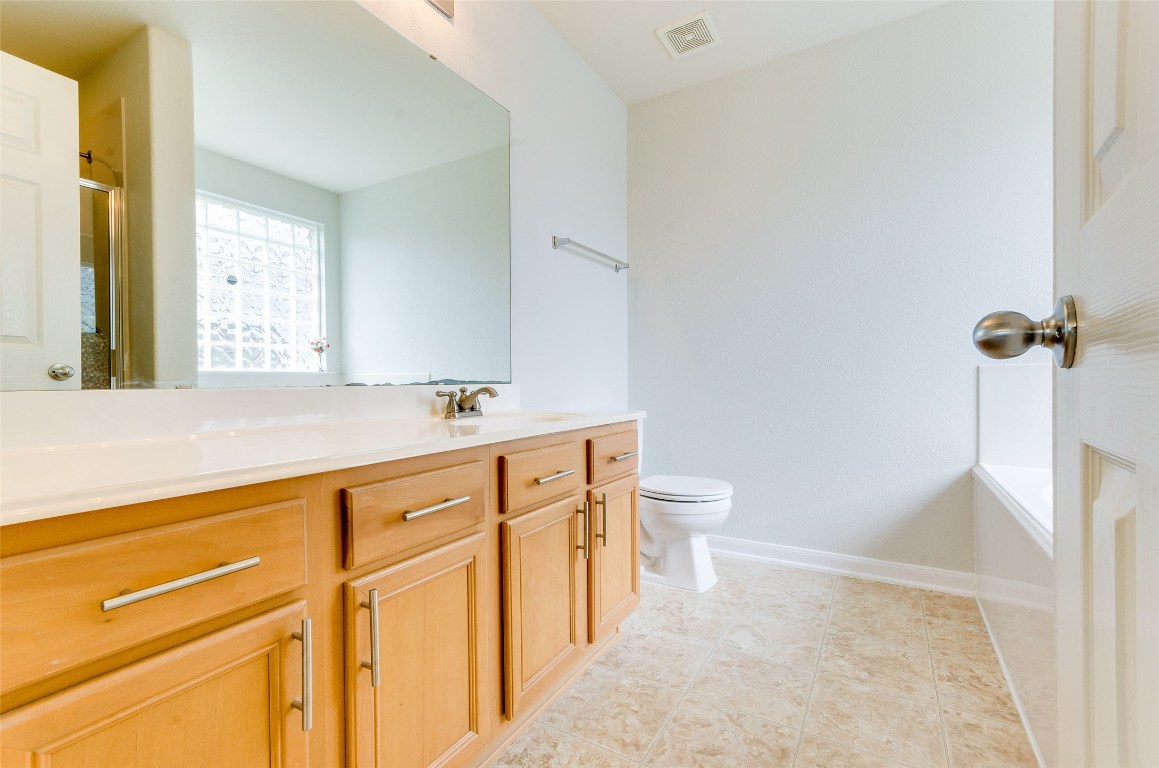 3302 Legends Landing Drive Spring, TX 77386 - Photo 35 of 48 a bathroom with a sink a toilet and a mirror