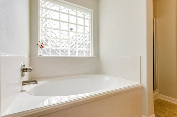 a white bath tub sitting next to a window