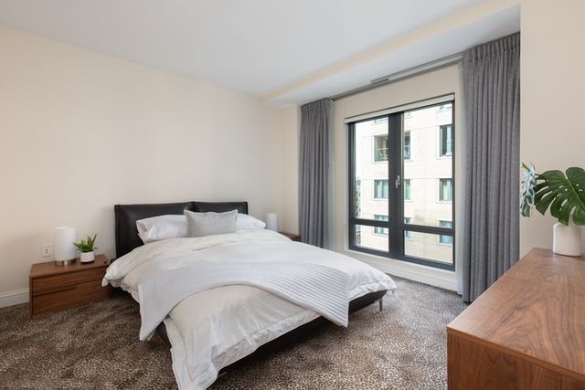 a bedroom with a bed and a window