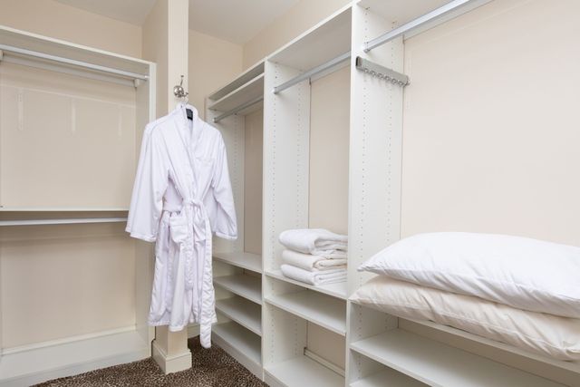 a bedroom with a bed and a mirror