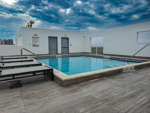 a view of swimming pool with seating space