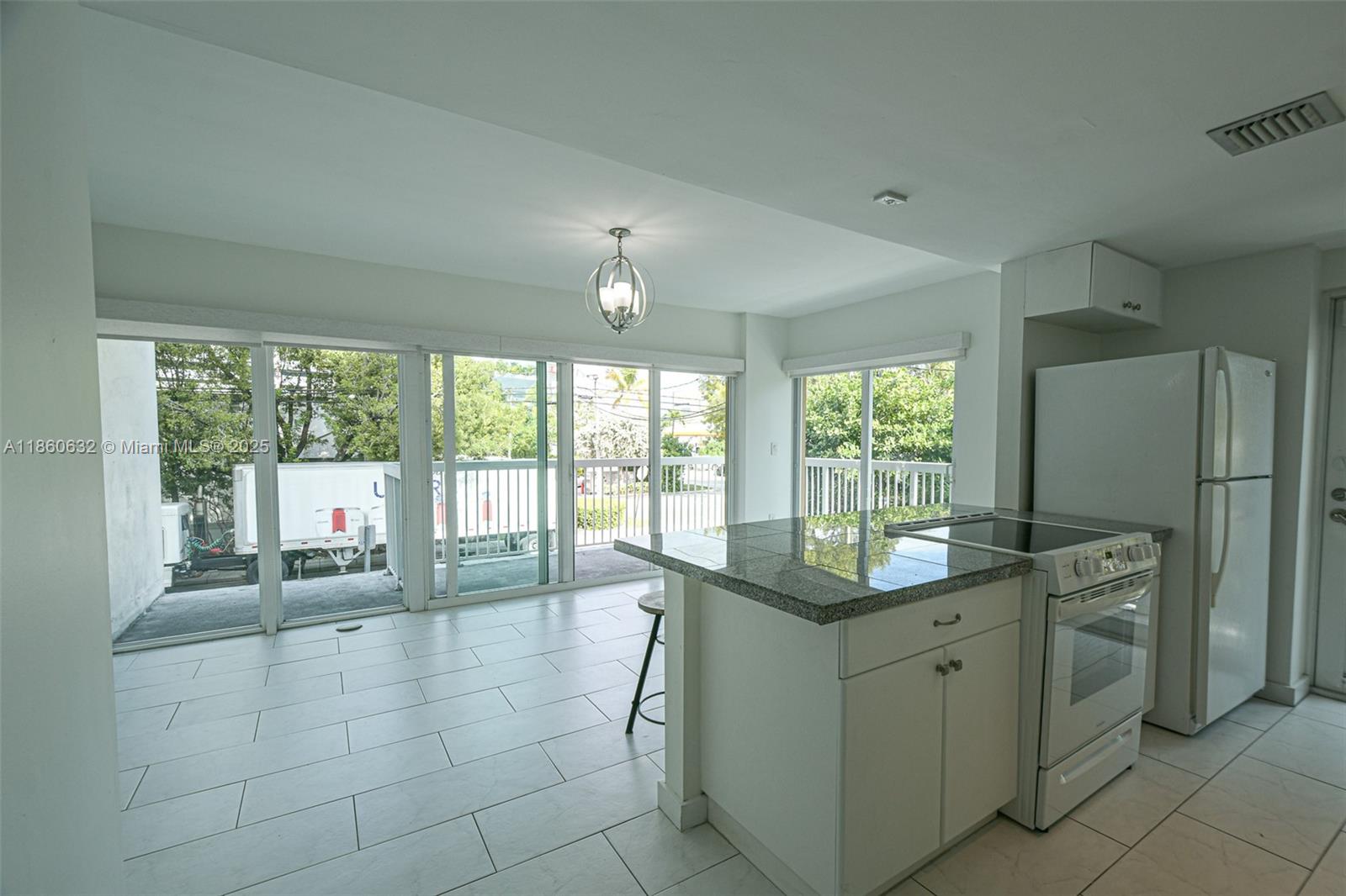 2740 Southwest 28th Terrace, Unit 201 Miami, FL 33133 - Photo 2 of 15 a room with a bed and large windows