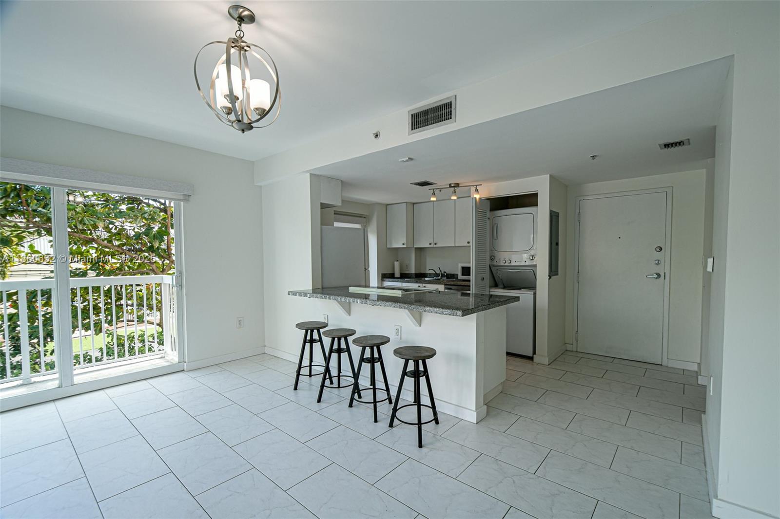 2740 Southwest 28th Terrace, Unit 201 Miami, FL 33133 - Photo 5 of 15 a large kitchen with a table and chairs