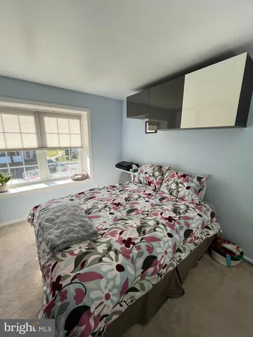 a bed sitting in a room next to a window