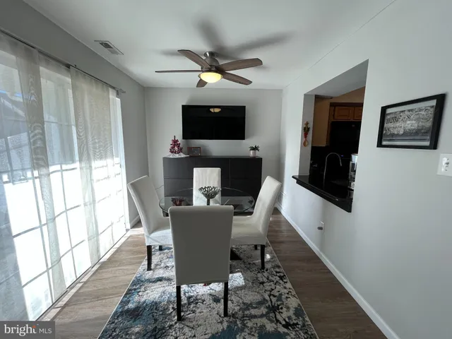 a view of a dining room with furniture window and wooden floor