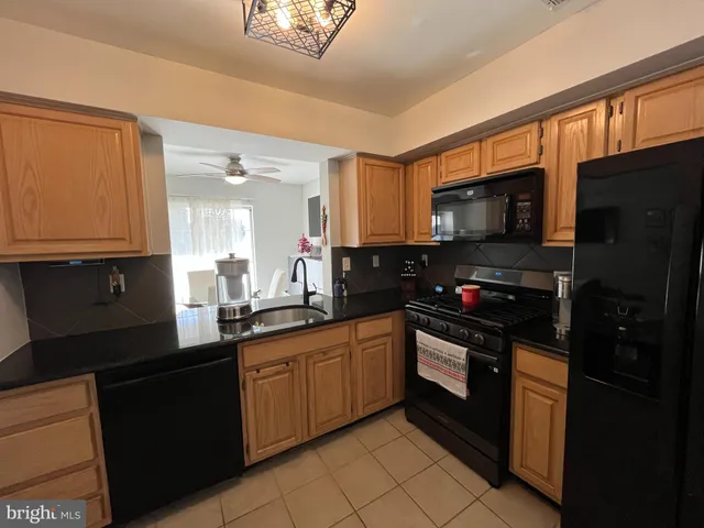 a kitchen with a sink stainless steel appliances and cabinets