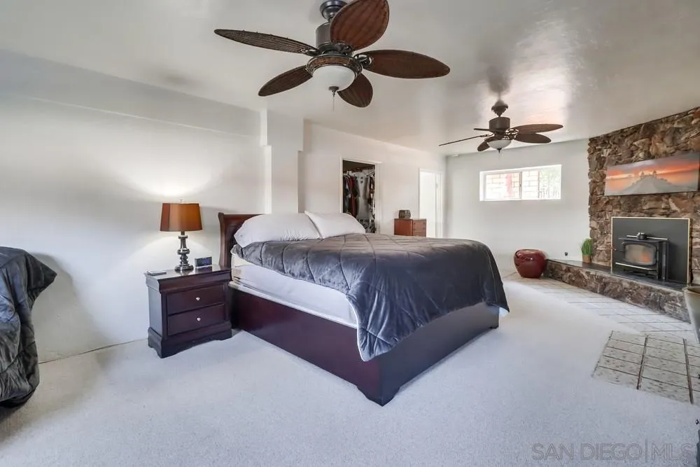 12718 Willow Road Lakeside, CA 92040 - Photo 17 of 46 a bedroom with a bed and a tv
