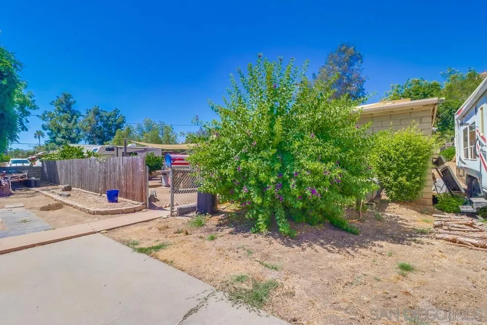 12718 Willow Road Lakeside, CA 92040 - Photo 23 of 46 a backyard of a house with table and chairs plants and large tree