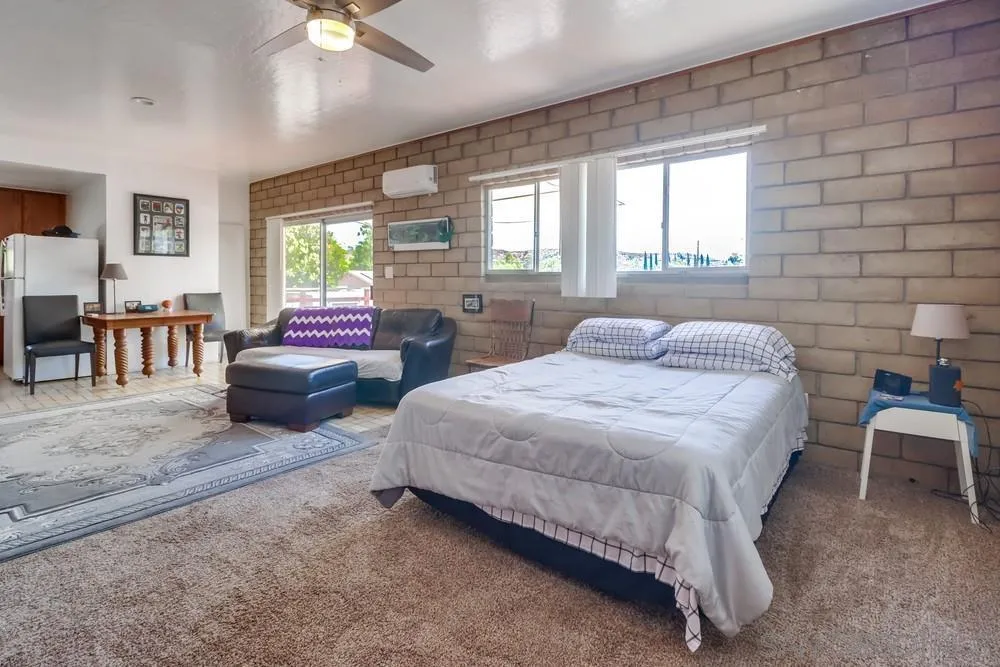 12718 Willow Road Lakeside, CA 92040 - Photo 28 of 46 a bedroom with a bed and a chandelier