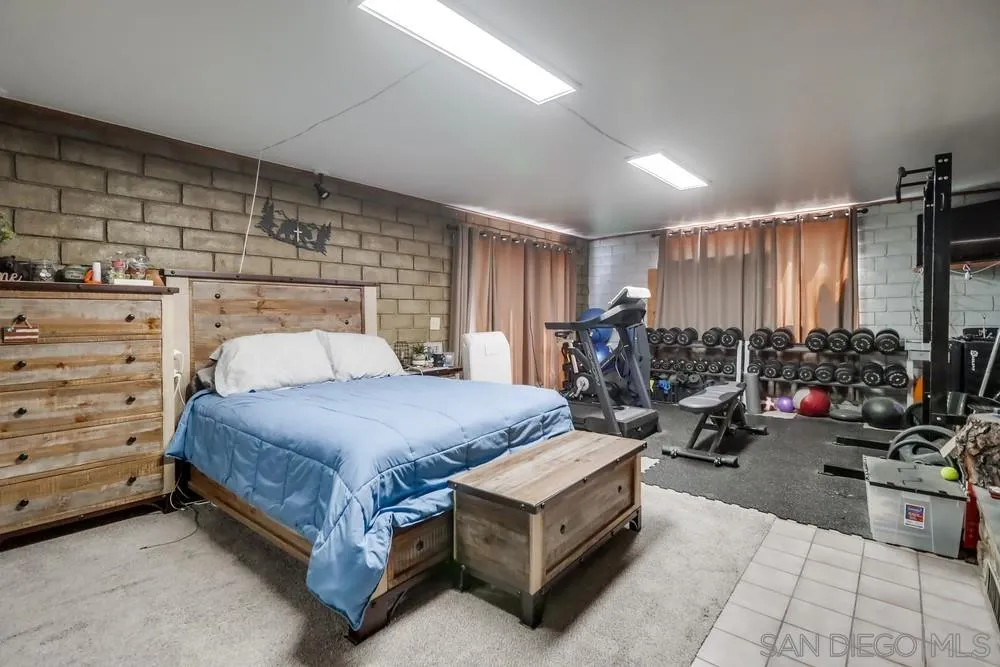 12718 Willow Road Lakeside, CA 92040 - Photo 34 of 46 a bed room with a bed and a night stand