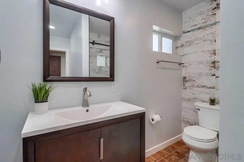 12718 Willow Road Lakeside, CA 92040 - Photo 5 of 46 a bathroom with a sink a toilet and mirror