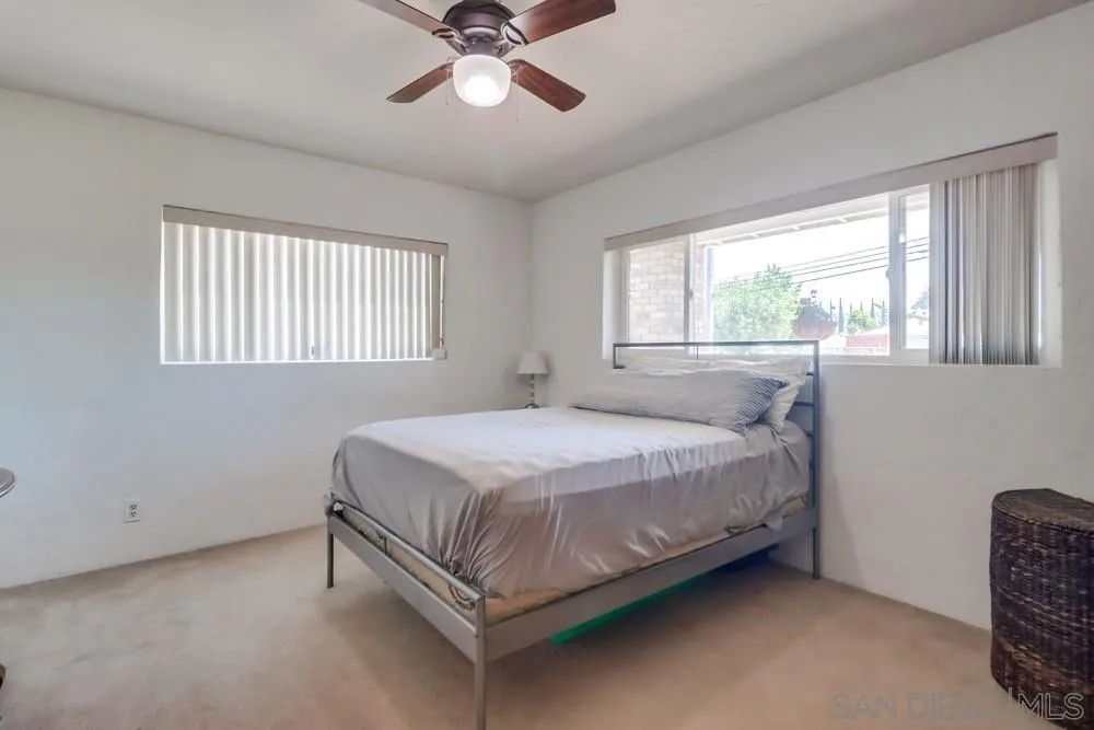 12718 Willow Road Lakeside, CA 92040 - Photo 6 of 46 a bed sitting in a bedroom next to a window