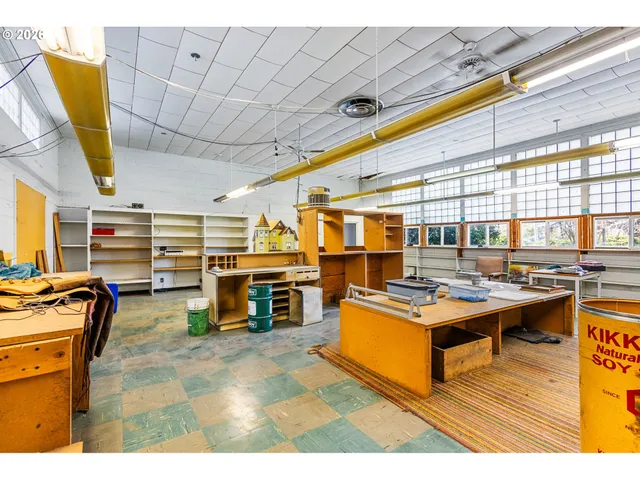 a living room with furniture and a dining table
