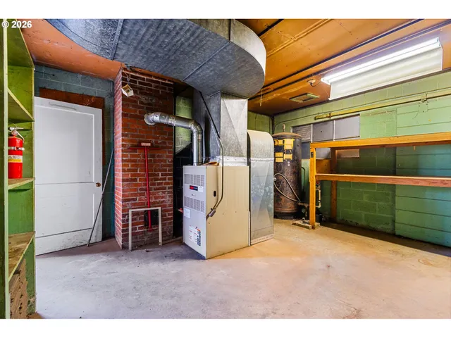 a view of kitchen with stainless steel appliances granite countertop a sink window and cabinets