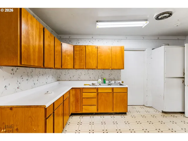 a bedroom with a bed and a view of kitchen