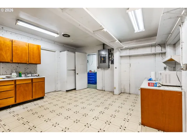 a kitchen with a refrigerator and a sink