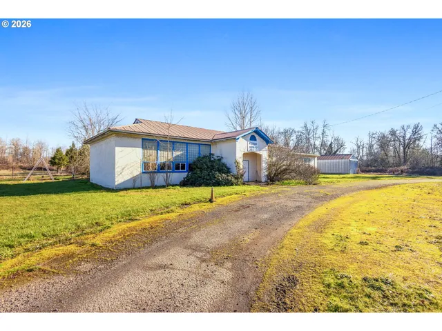 a swimming pool with outdoor seating and yard