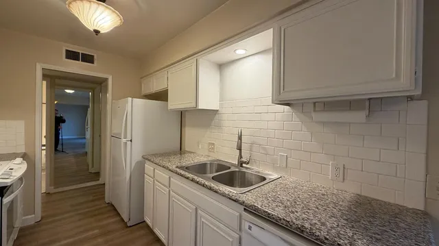 a kitchen with a sink and refrigerator