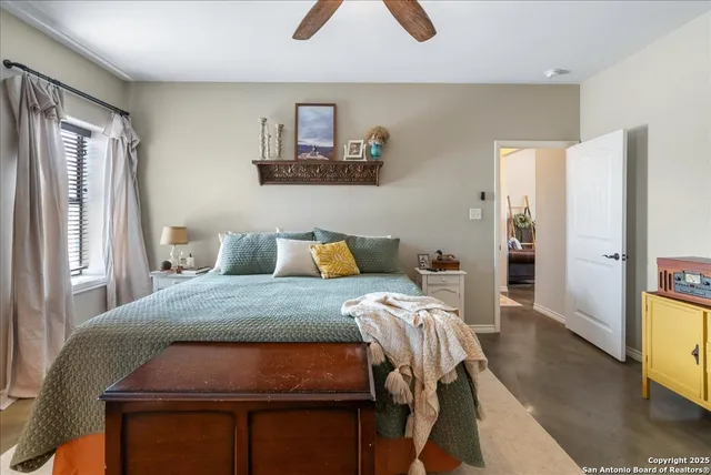 a bed sitting in a bedroom next to a window