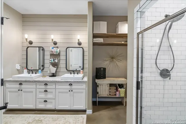 a bathroom with a granite countertop sink a vanity and a mirror