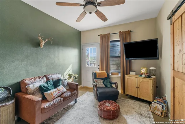 a living room with furniture and a flat screen tv