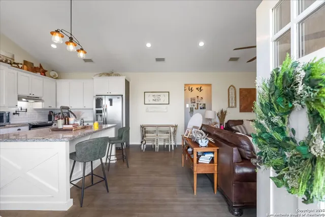 a living room with furniture and a potted plant