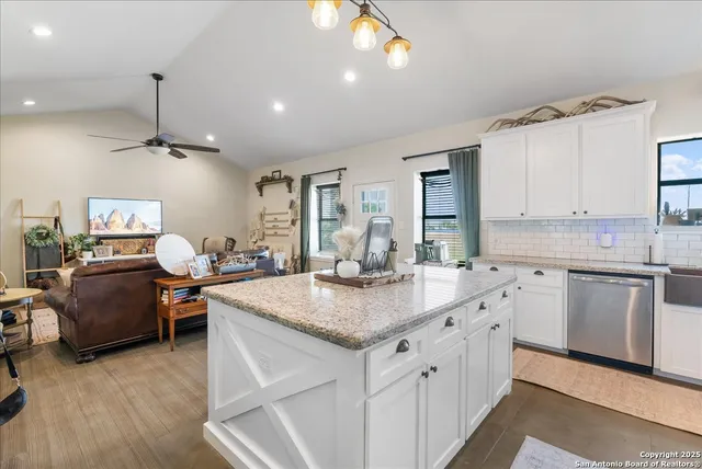 a kitchen with sink cabinets and wooden floor
