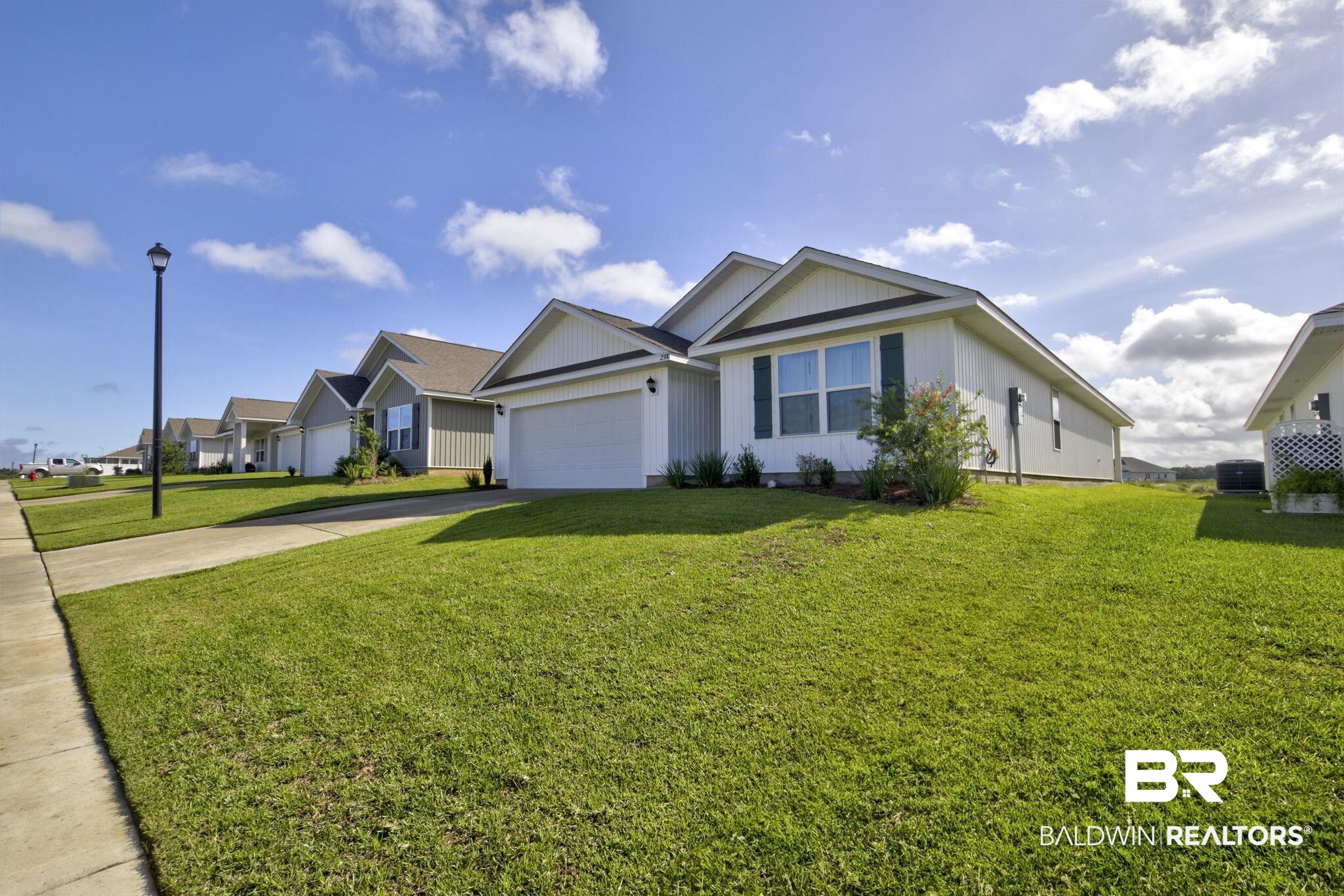 23810 Unbridled Loop Daphne, AL 36526 - Photo 2 of 50 Ranch-style house with a front yard and a garage