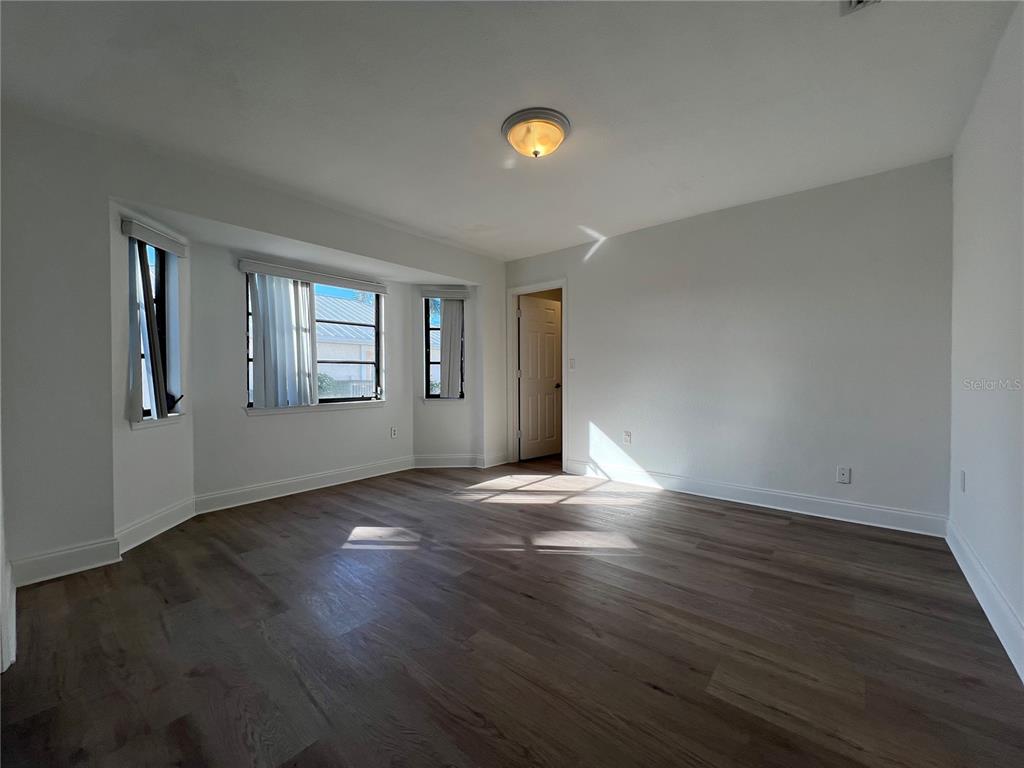 2092 Rio De Janeiro Avenue Punta Gorda, FL 33983 - Photo 25 of 50 a view of an empty room with wooden floor and a window