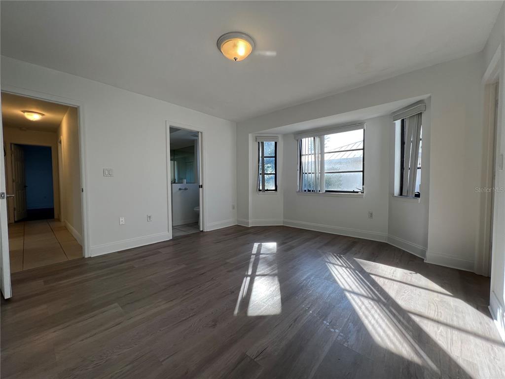 2092 Rio De Janeiro Avenue Punta Gorda, FL 33983 - Photo 27 of 50 an empty room with wooden floor and windows