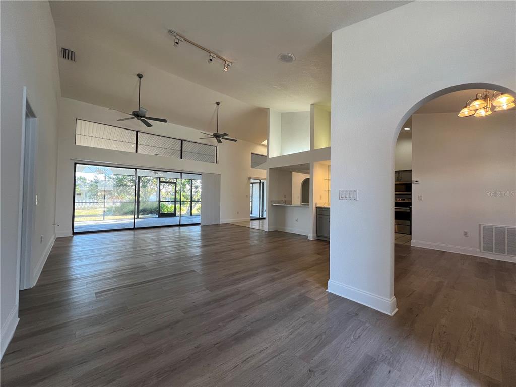 2092 Rio De Janeiro Avenue Punta Gorda, FL 33983 - Photo 3 of 50 an empty room with wooden floor and windows