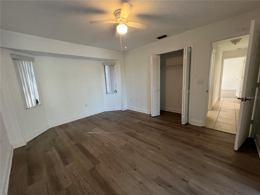 2092 Rio De Janeiro Avenue Punta Gorda, FL 33983 - Photo 34 of 50 a view of empty room with wooden floor and fan