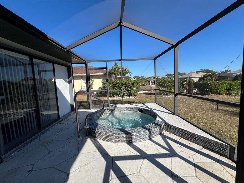 2092 Rio De Janeiro Avenue Punta Gorda, FL 33983 - Photo 38 of 50 a view of a patio with a table and chairs under an umbrella