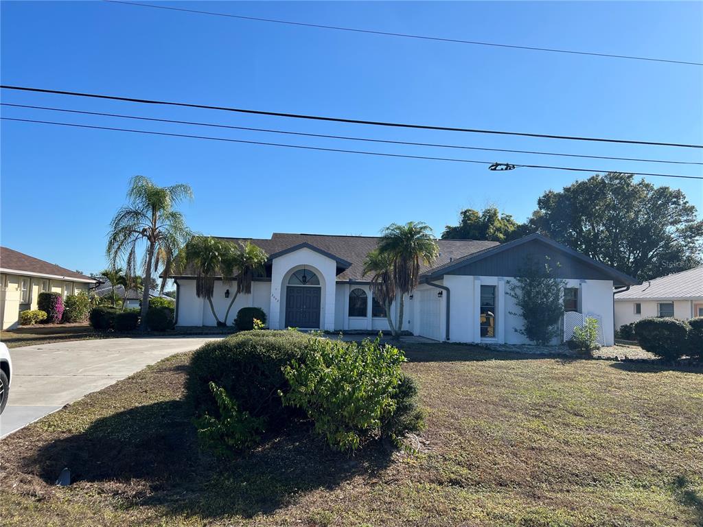 2092 Rio De Janeiro Avenue Punta Gorda, FL 33983 - Photo 45 of 50 a front view of a house with a yard and potted plants