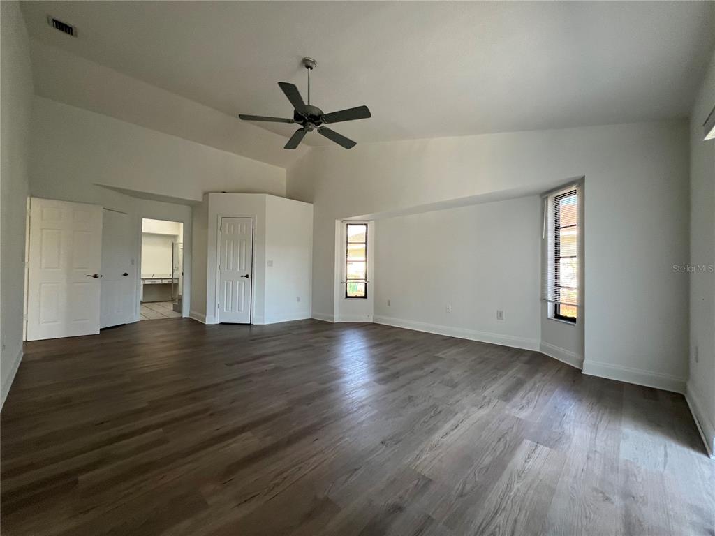 2092 Rio De Janeiro Avenue Punta Gorda, FL 33983 - Photo 7 of 50 an empty room with wooden floor and windows