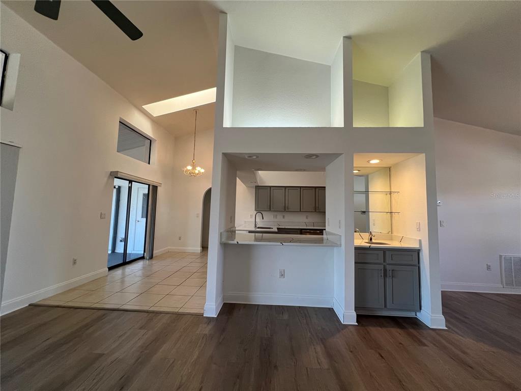 2092 Rio De Janeiro Avenue Punta Gorda, FL 33983 - Photo 10 of 50 a kitchen with granite countertop a refrigerator and a stove top oven