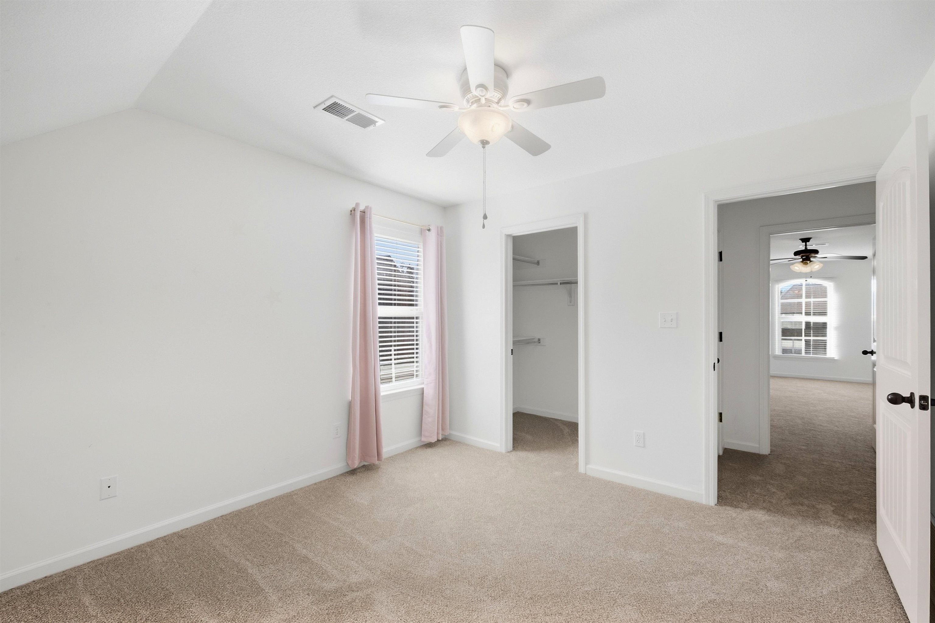 7920 Pips Ridge Lane Bartlett, TN 38133 - Photo 28 of 40 Carpeted room featuring a ceiling fan, window with blinds, and a walk-in closet with shelving