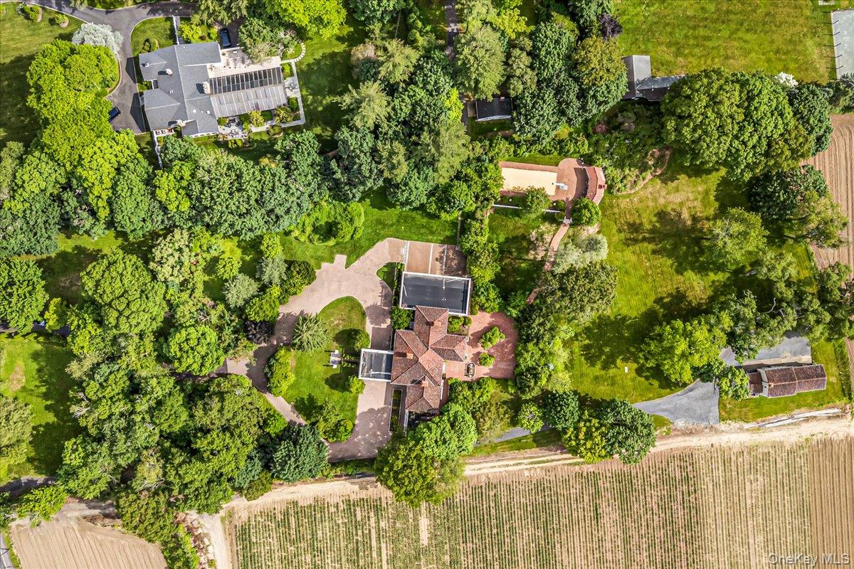 952 Cedar Swamp Road Glen Head, NY 11545 - Photo 3 of 50 an aerial view of a house with a yard and trees