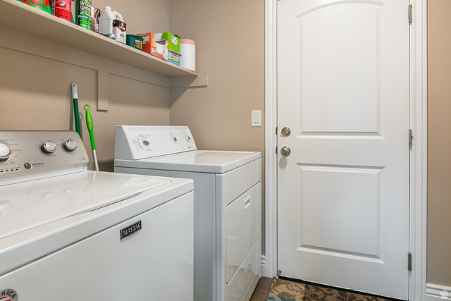 1228 North Providence Way Tooele, UT 84074 - Photo 12 of 28 Dedicated laundry area featuring a built-in shelving unit, neutral wall paint, and a white paneled door with brushed nickel hardware