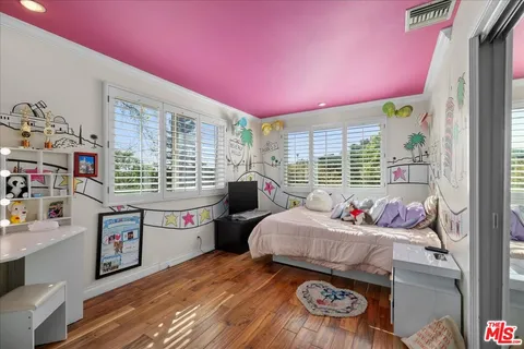 a bedroom with furniture and a window