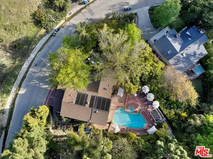 an aerial view of house with yard swimming pool and outdoor seating
