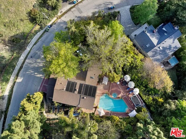 an aerial view of house with yard swimming pool and outdoor seating