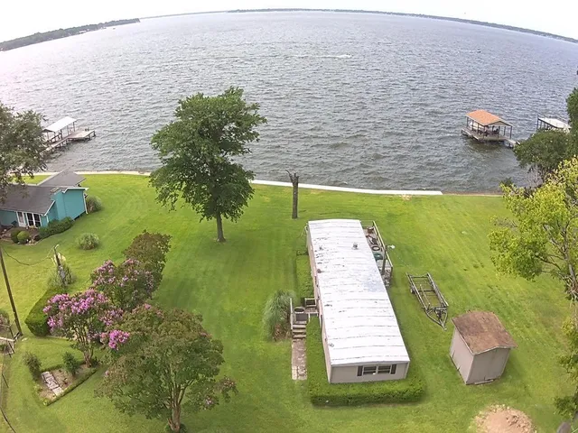 a view of a lake with a floor to ceiling window
