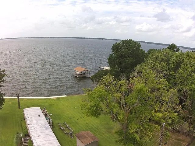 a view of a lake with a yard