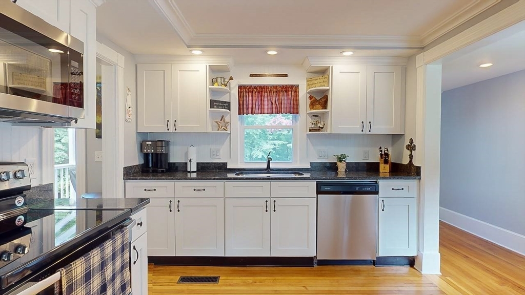509 Mendon Road Sutton, MA 01590 - Photo 15 of 42 a kitchen with stainless steel appliances granite countertop a stove a sink and white cabinets