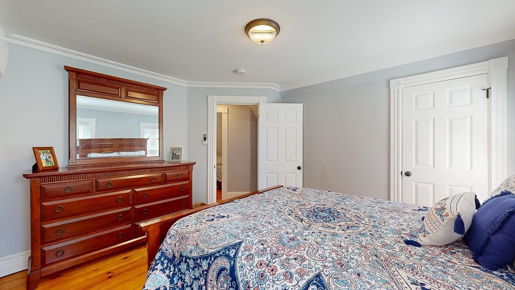 509 Mendon Road Sutton, MA 01590 - Photo 33 of 42 a bedroom with a bed and a dresser with mirror