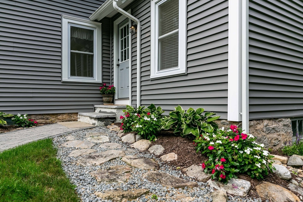 509 Mendon Road Sutton, MA 01590 - Photo 6 of 42 a view of a house with a yard and a garden