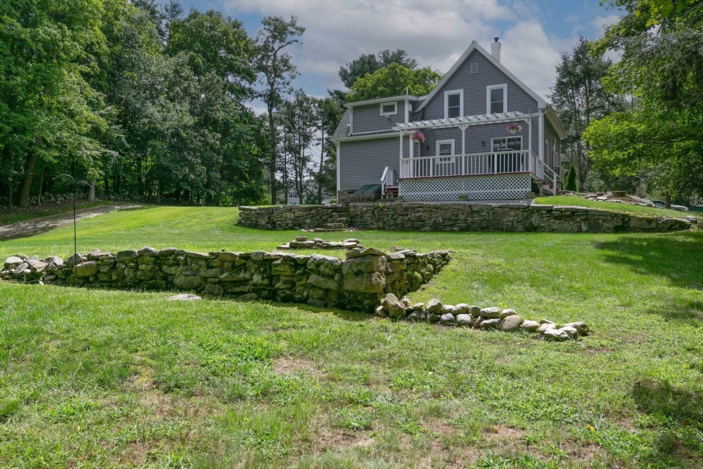 509 Mendon Road Sutton, MA 01590 - Photo 9 of 42 a front view of a house with a yard