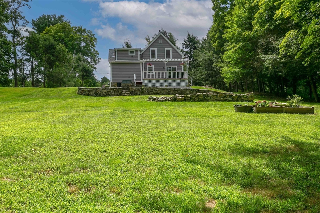 509 Mendon Road Sutton, MA 01590 - Photo 10 of 42 a front view of a house with a yard